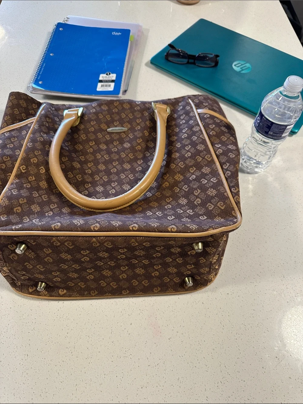This is a brown Pierre Cardin monogram logo tote bag with beige leather handles.